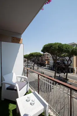 a balcony with a table and chairs and a view of a street at DaVinci Relais Guest House in Rome