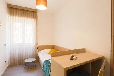a small room with a bed and a desk at DaVinci Relais Guest House in Rome