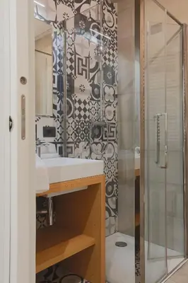 a bathroom with a shower and a white sink at DaVinci Relais Guest House in Rome