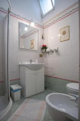 a bathroom with a sink and a toilet and a mirror at Forum Apartment in Rome