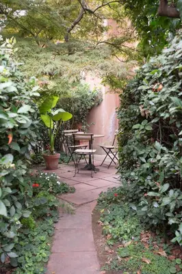 a patio with a table and bench in a garden at Forum Apartment in Rome