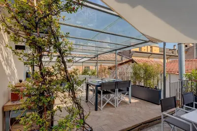 a patio with a table and some plants at Casa Modelli in Rome