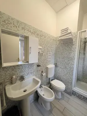 a bathroom with a white sink and a toilet at Sole E Luna in Rome