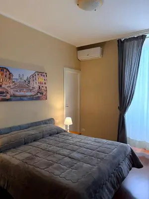 a bedroom with a large bed and a window at Sole E Luna in Rome