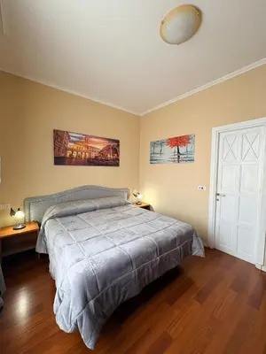a bedroom with a bed and a white door at Sole E Luna in Rome