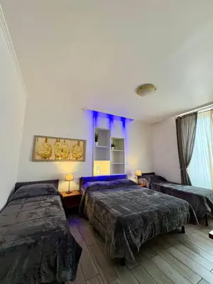 a bedroom with two beds and blue lighting at Sole E Luna in Rome
