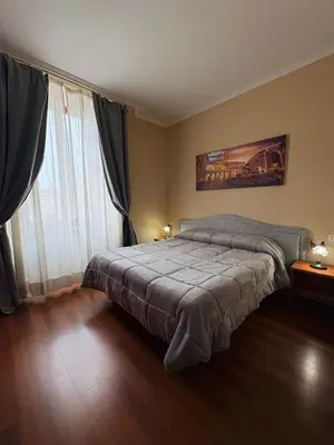 a bedroom with a bed and a large window at Sole E Luna in Rome