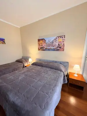 a bedroom with a bed and a painting on the wall at Sole E Luna in Rome