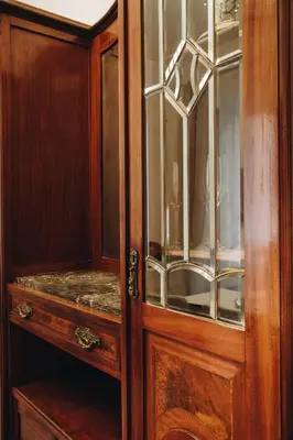 a wooden cabinet with glass doors and a counter at Suite Rondanini in Rome