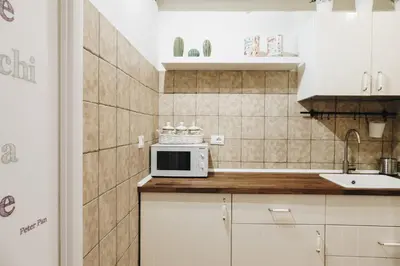 a small kitchen with a microwave and a sink at Suite Rondanini in Rome