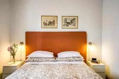 a bedroom with a large bed with two night stands at Circus Maximus Home in Rome