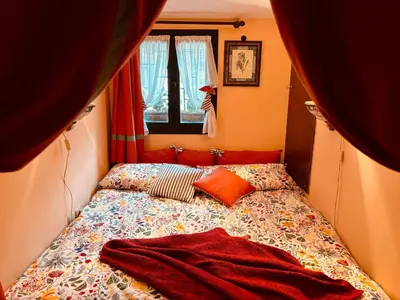 a bed in a small room with a blanket on it at Paradiso Borgia in Rome