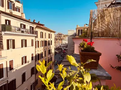 a view from the balcony of a building with flowers in a pot at Paradiso Borgia in Rome