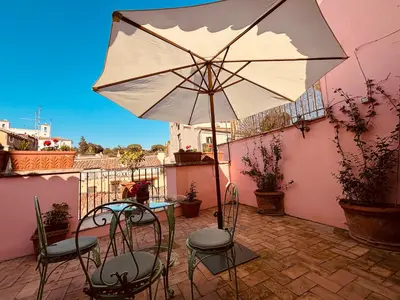 a patio with a table and an umbrella at Paradiso Borgia in Rome