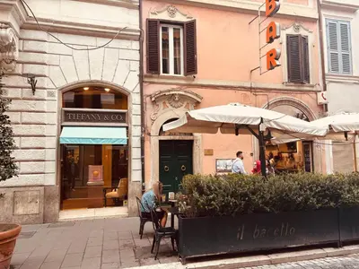 a table with umbrellas in front of a building at Paradiso Borgia in Rome