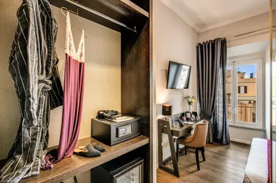 a hotel room with a desk and a television at Piccola Navona Roof Garden in Rome