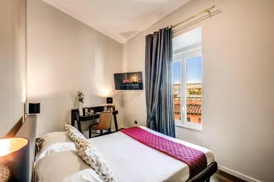 a room with two beds and a window at Piccola Navona Roof Garden in Rome