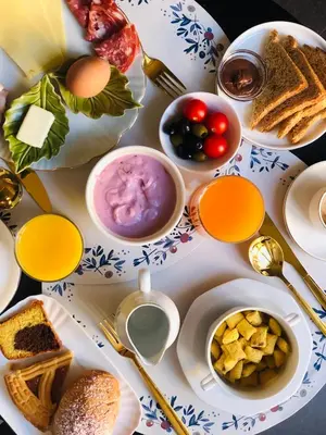 a table topped with plates of food and drinks at Piccola Navona Roof Garden in Rome