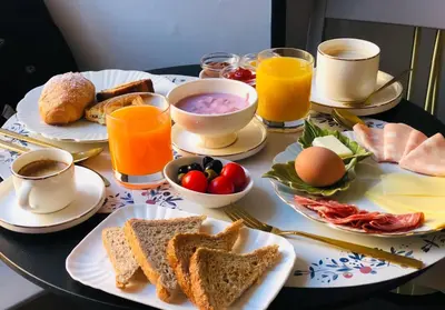 a table topped with plates of breakfast foods and drinks at Piccola Navona Roof Garden in Rome