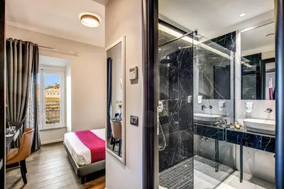 a bathroom with a glass shower and a sink at Piccola Navona Roof Garden in Rome