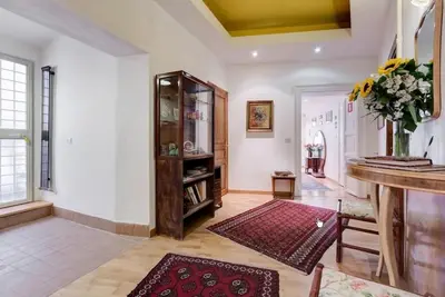 a large living room with a counter and a table at ROMA CENTER, Rione Monti, Apartament in Rome
