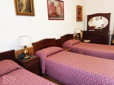 a bedroom with three beds and a mirror at ROMA CENTER, Rione Monti, Apartament in Rome