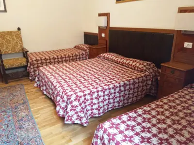 a hotel room with two beds and a chair at ROMA CENTER, Rione Monti, Apartament in Rome