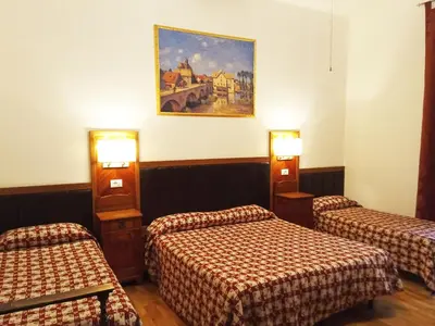 a hotel room with two beds and a painting on the wall at ROMA CENTER, Rione Monti, Apartament in Rome