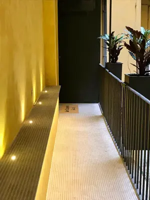 an empty walkway with a door and plants on it at san cosimato suite in Rome