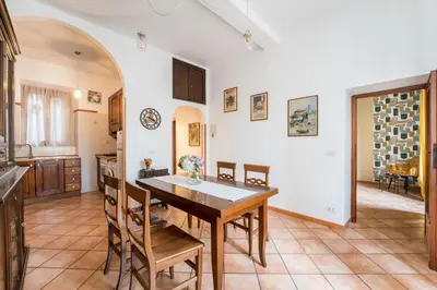 a kitchen and dining room with a table and chairs at FL Apartments Al Mattonato n4 in Rome