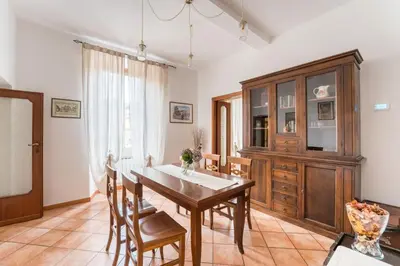 a dining room with a wooden table and chairs at FL Apartments Al Mattonato n4 in Rome