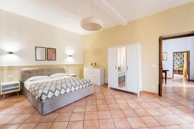 a bedroom with a bed and a tiled floor at FL Apartments Al Mattonato n4 in Rome