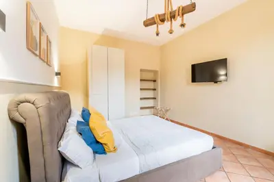 a bedroom with a bed and a tv on the wall at FL Apartments Al Mattonato n4 in Rome
