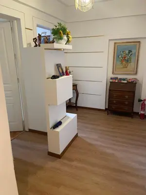 a living room with white shelves in a room at Le Petit Real in Rome