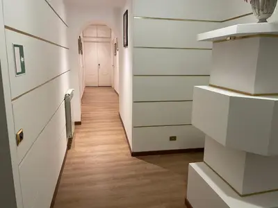 a hallway with white walls and a white door at Le Petit Real in Rome