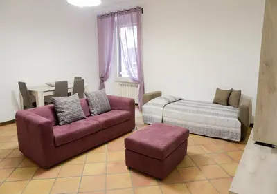 a living room with a couch and a bed at Colosseum Comfortable Apartment in Rome