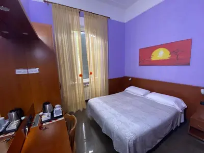 a bedroom with a bed and a desk with a computer at tagliaferri lucia in Rome