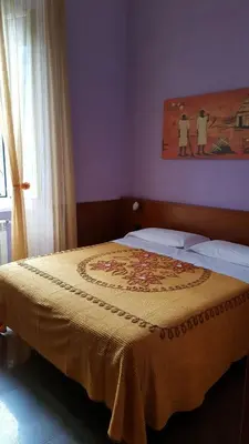 a bedroom with a bed with a yellow blanket on it at tagliaferri lucia in Rome