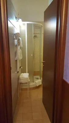 a bathroom with a shower and a chair in a room at tagliaferri lucia in Rome