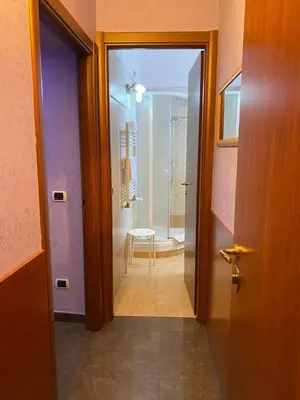 a hallway with a door leading to a bathroom at tagliaferri lucia in Rome