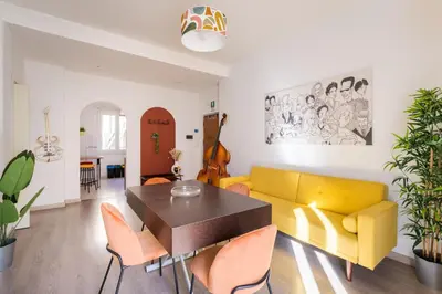a living room with a yellow couch and a table at House Of Music in Rome