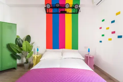 a bedroom with a bed with a colorful wall at House Of Music in Rome