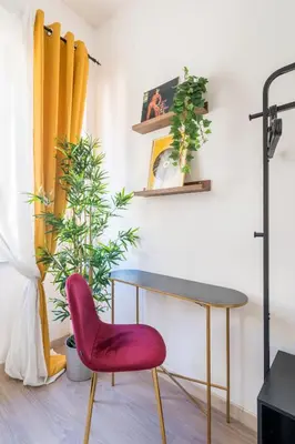 a desk and a chair in a room with plants at House Of Music in Rome