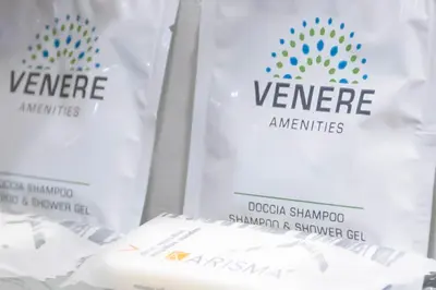 a group of white bags with thevenne ames logo on them at 2 Passi Da in Rome