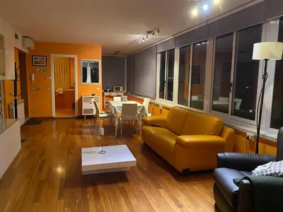 a living room with a yellow couch and a table at Domus Mirabile in Rome