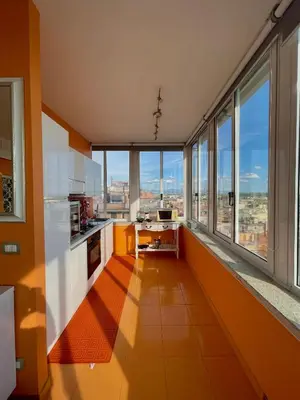 a kitchen with orange walls and large windows at Domus Mirabile in Rome