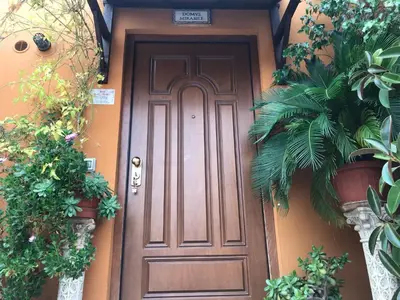 a wooden door on a house with plants at Domus Mirabile in Rome