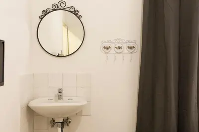 a bathroom with a sink and a mirror at Central Apartment Navona Square in Rome