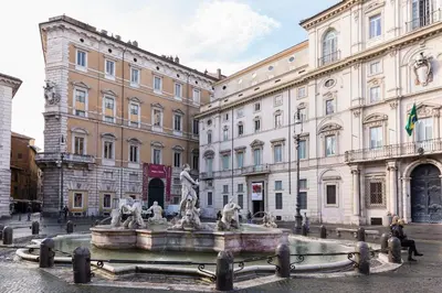 a fountain in a courtyard in front of a building at Central Apartment Navona Square in Rome