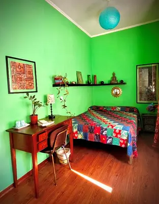 a bedroom with green walls and a bed and a desk at 4321 B&B Stazione Trastevere in Rome